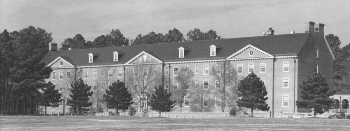 Rear facade of Landrum Hall, a four story brick dorm facing Barksdale Field
