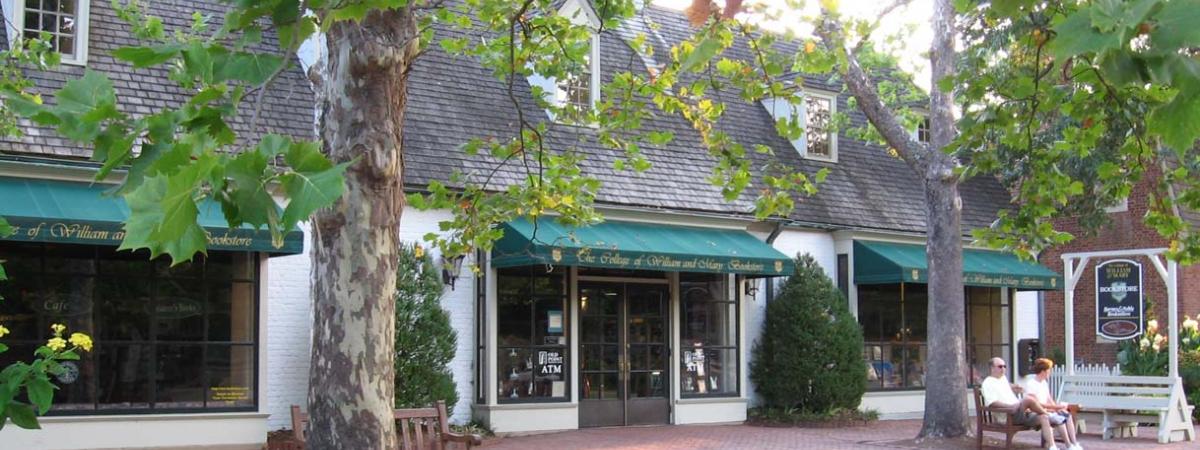 The bookstore, circa 2008, in Colonial Williamsburg. The two story white clad building has green awnings over the entrance.