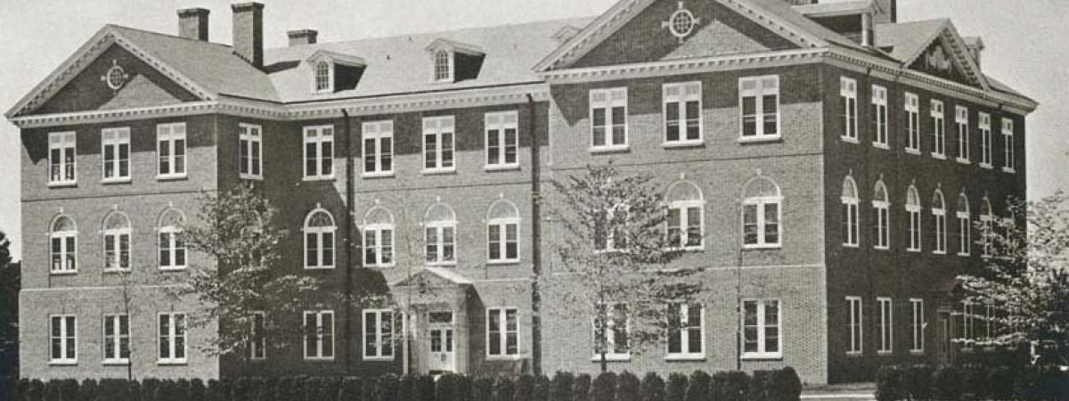Black and white of James Blair hall, a three story brick building with wings on both sides