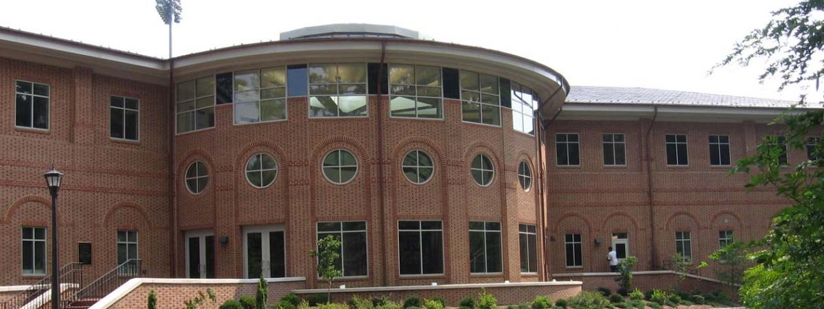 Three story brick and glass Football Center with central round room
