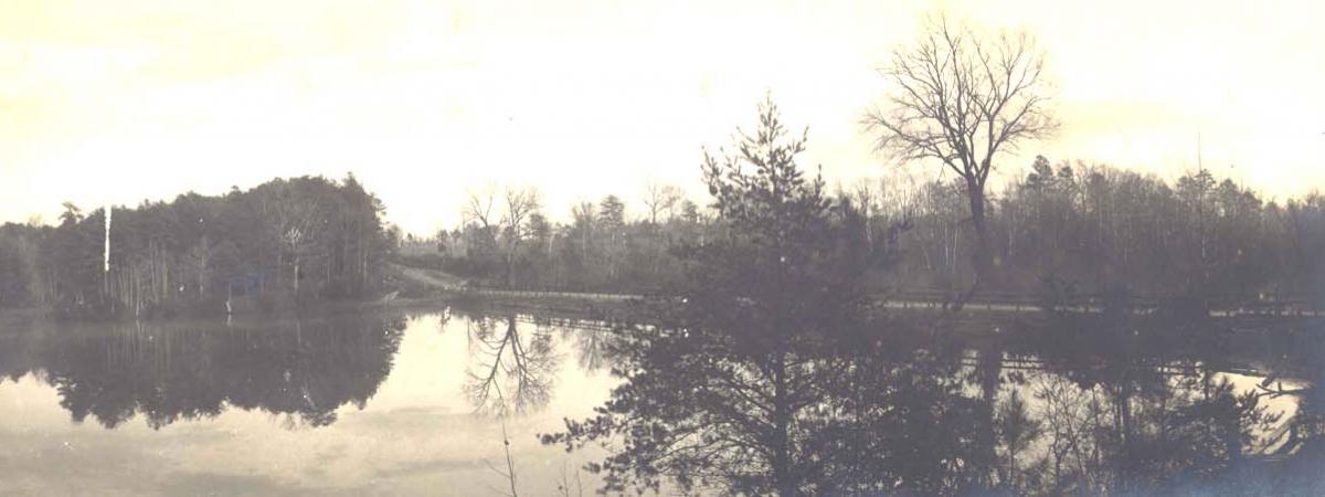 Black and white photo that has yellowed with age of the lake
