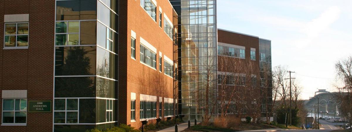 Three story brick building with glass enclosed central staircase