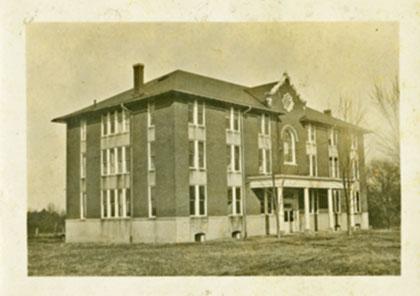 Three story brick building with covered entrance