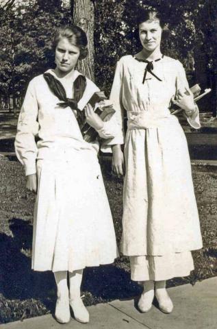 Janet_Coleman_and_Alice_Person_1919 Black and white photo of Coleman Kimbrough standing in front of a tree and wearing white dresses