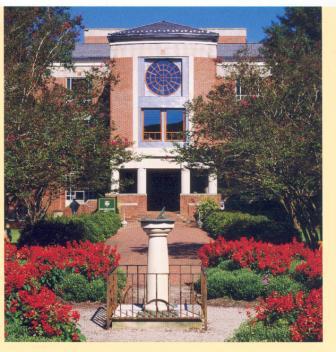 Front entrance to Swem Library, featuring a covered portico for the entrance and round window on the third floor