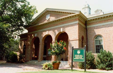 Front entrance of Tucker Hall featuring three brick arches and wide stepped platform