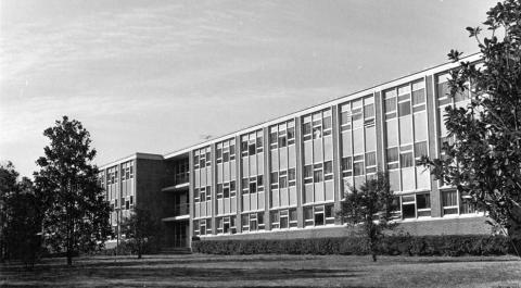 Black and white photo of the three story brick Yates dormitory