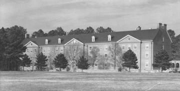 Rear facade of Landrum Hall, a four story brick dorm facing Barksdale Field