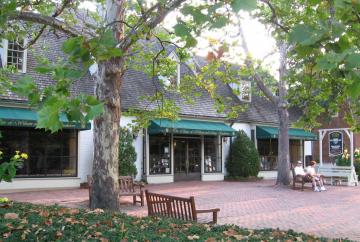 The bookstore, circa 2008, in Colonial Williamsburg. The two story white clad building has green awnings over the entrance.