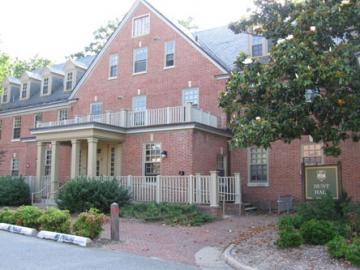 Three story brick building with columned entrance