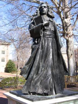 Statue of James Blair standing with a book in hand and wearing swirling robes