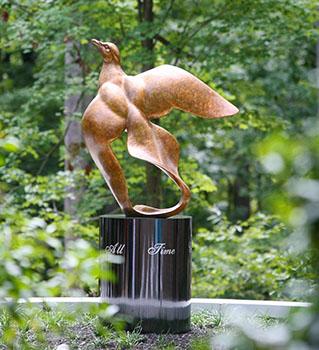 Metal statue of a dove in flight