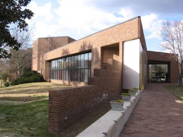 The Muscarelle Museum building featuring large glass windows and angular entry