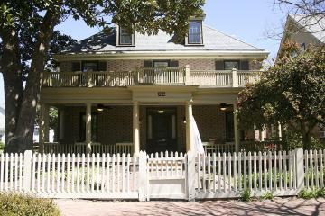 Two story brick house with covered porch in Sorority Court